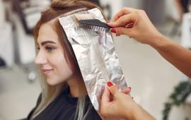 Hairdresser colored hair her client. Woman in a hair salon