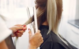 Hairdresser working with hear her client. Woman in a hair salon